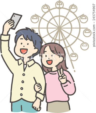 A young couple taking a selfie in front of a Ferris wheel. A young couple taking a selfie in front of a Ferris wheel. 143754907