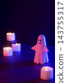 Halloween image with ghosts and candles (using colored lights and filters) 143755317