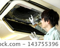 一名男工人在檢查商用空調的內部。 143755396