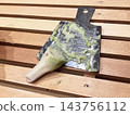 A metal grater and freshly grated raw wasabi 143756112