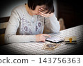 Middle-aged and senior women worrying while calculating money on a calculator. 143756363