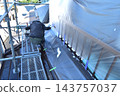 Renovation work on a detached house: A scene of a painter at work. 143757037