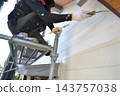 Renovation work on a detached house: A scene of a painter at work. 143757038
