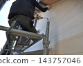 Renovation work on a detached house: A scene of a painter at work. 143757046