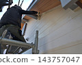 Renovation work on a detached house: A scene of a painter at work. 143757047