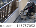 Renovation work on a detached house: A scene of a painter at work. 143757052