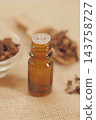 Amber glass bottle with a dropper cap on a burlap surface 143758727