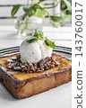 gourmet sweet french toast with madagascar vanilla ice cream and organic honey roasted granola on white cafe table outdoor 143760017