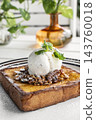 gourmet sweet french toast with madagascar vanilla ice cream and organic honey roasted granola on white cafe table outdoor 143760018