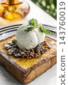 gourmet sweet french toast with madagascar vanilla ice cream and organic honey roasted granola on white cafe table outdoor 143760019