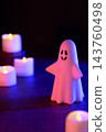 Halloween image featuring ghosts and candles (using colored lights) 143760498