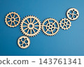 Interlocking wooden gears symbolize teamwork in business. 143761341