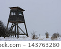 Wooden watchtower stands in snowy field 143763280