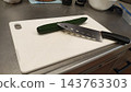 Kitchen utensils and cucumbers to prepare for cutting vegetables in the kitchen 143763303