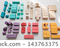 Colorful wooden building blocks scattered on white background for early childhood education 143763375