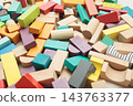 Colorful wooden building blocks scattered on white background for early childhood education 143763377