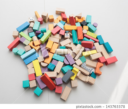 Colorful wooden building blocks scattered on white background for early childhood education Colorful wooden building blocks scattered on white background for early childhood education 143763378