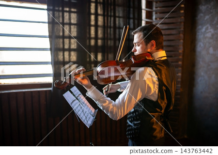 Portrait of a man playing violin Portrait of a man playing violin 143763442