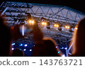 Concert stage lights above crowd at night 143763721