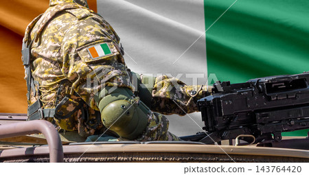Ivory Coast flag with soldier at machinegun turret Ivory Coast flag with soldier at machinegun turret 143764420