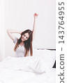 Girl yawning in bed. 143764955