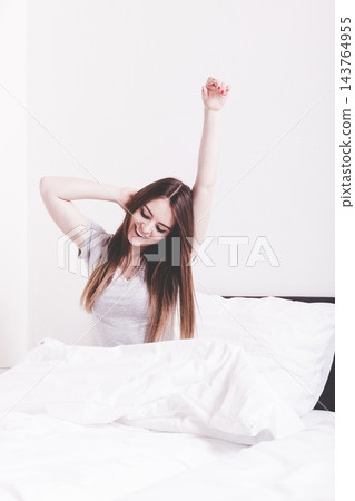 Girl yawning in bed. Girl yawning in bed. 143764955