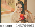 Woman sitting on chair relaxing at home 143764963