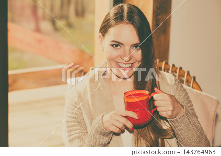 Woman sitting on chair relaxing at home Woman sitting on chair relaxing at home 143764963