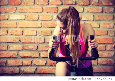 Active woman doing sport biking. Active woman doing sport biking. 143764965