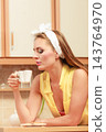Pretty pin up girl drinking tea or coffee at home. 143764970