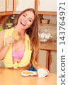 Girl with tea coffee eating gingerbread cookie. 143764971