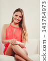 Cute fashion woman in red shirt on sofa couch. 143764973