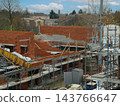 Construction worker laying bricks on building site 143766647