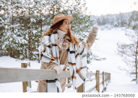 Woman traveler in a hat with a backpack on a wooden ladder. Active lifestyle. Travel concept. Woman traveler in a hat with a backpack on a wooden ladder. Active lifestyle. Travel concept. 143768008