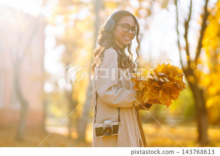 Beautiful woman taking pictures in the autumn forest. Rest, relaxation, tourism, lifestyle concept. Beautiful woman taking pictures in the autumn forest. Rest, relaxation, tourism, lifestyle concept. 143768613