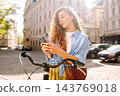 Attractive woman taking selfie with bike on street of old Communication with friends. Selfie time. 143769018