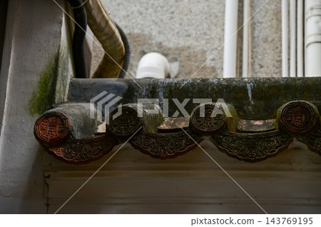 Close-up of the traditional, Chinese classic roof tiles of Chinese building, Chinese architecture in China Garden. Chinese historical building. Travel scene. Building exterior. 143769195