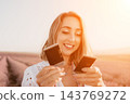 Woman lavender photographs smiling young lady holding instant pictures in purple field at sunset during summer travel 143769272