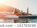 Woman Paddleboard Ocean Relaxing on Paddleboard in Ocean 143769286