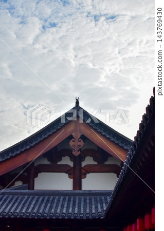 Close-up of the ornate decor on the Chinese classic roof of traditional building, Chinese architecture in China. Chinese folk religion landmark. Buddhist Temple or traditional building. Close-up of the ornate decor on the Chinese classic roof of traditional building, Chinese architecture in China. Chinese folk religion landmark. Buddhist Temple or traditional building. 143769430