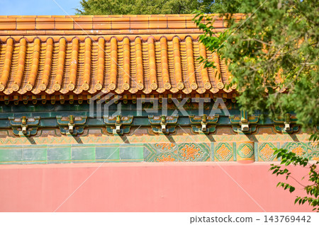 Close-up of the ornate decor on the Chinese classic roof of traditional building, Chinese architecture in China. Chinese folk religion landmark. Buddhist Temple or traditional building. Close-up of the ornate decor on the Chinese classic roof of traditional building, Chinese architecture in China. Chinese folk religion landmark. Buddhist Temple or traditional building. 143769442