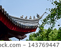 Close-up of the ornate decor on the Chinese classic roof of traditional building, Chinese architecture in China. Chinese folk religion landmark. Buddhist Temple or traditional building. 143769447