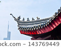 Close-up of the ornate decor on the Chinese classic roof of traditional building, Chinese architecture in China. Chinese folk religion landmark. Buddhist Temple or traditional building. 143769449