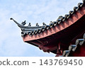 Close-up of the ornate decor on the Chinese classic roof of traditional building, Chinese architecture in China. Chinese folk religion landmark. Buddhist Temple or traditional building. 143769450