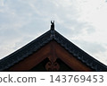 Close-up of the ornate decor on the Chinese classic roof of traditional building, Chinese architecture in China. Chinese folk religion landmark. Buddhist Temple or traditional building. 143769453