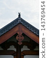 Close-up of the ornate decor on the Chinese classic roof of traditional building, Chinese architecture in China. Chinese folk religion landmark. Buddhist Temple or traditional building. 143769454