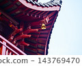 The close-up of a chain of bells under the eaves of the Chinese buddhist temple. Chinese architecture in China. Chinese folk religion landmark. Buddhist Temple or traditional building.  143769470