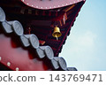 The close-up of a chain of bells under the eaves of the Chinese buddhist temple. Chinese architecture in China. Chinese folk religion landmark. Buddhist Temple or traditional building.  143769471