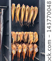 Smoked Fish Hanging in Traditional Smokehouse Rack Ready for Sale or Storage 143770048