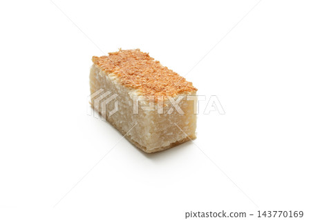 Delicious toasted coconut sweet slice isolated on a white backdrop. Ideal for bakery menus, traditional dessert marketing, candy packaging, and food blogs. 143770169